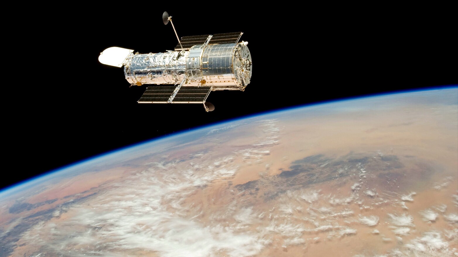 Hubble drifts over Earth after its release on May 19, 2009 by the crew of the Space Shuttle Atlantis. This was the fifth astronaut visit to the Hubble Space Telescope.